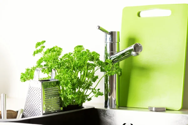 Faucet, grater and fresh parsley — Stock Photo, Image