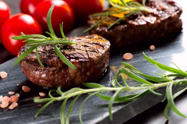 Grilled steak with rosemary and tomatoes clipart