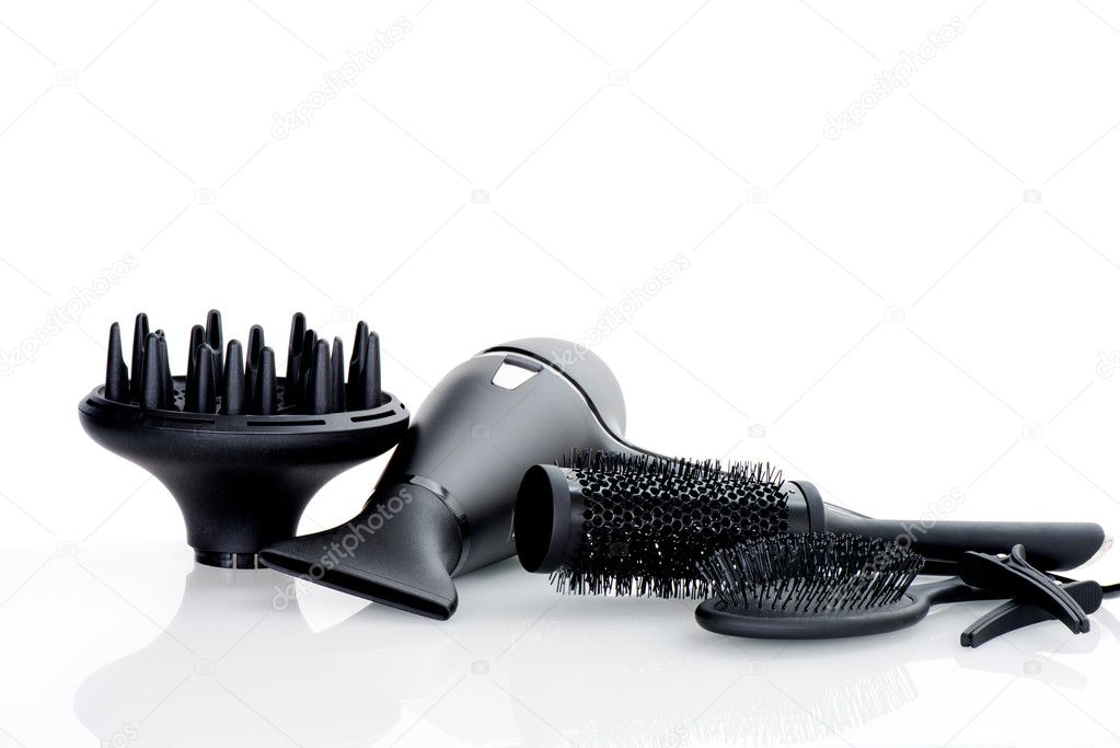 Hair dryer and tools on white background