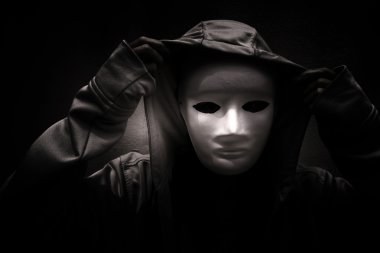 Dark doctrine,Mysterious woman wearing white mask under hoodie,Scary background for book cover clipart