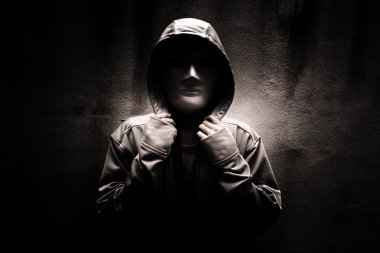 Dark doctrine,Mysterious woman wearing white mask under hoodie,Scary background for book cover clipart