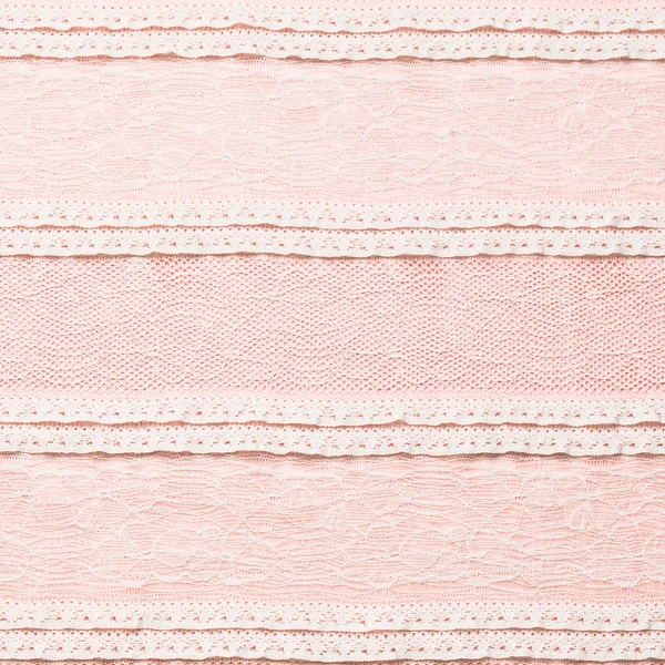 Tissu dentelle ivoire sur fond rose — Photo