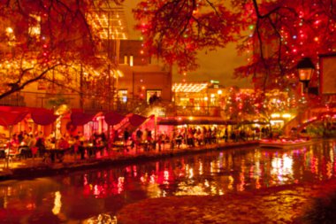 Blurred holiday background. River walk  in San Antonio city at n clipart