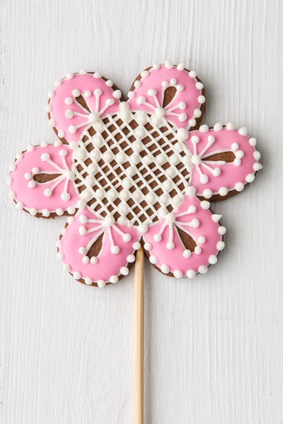 Flower shaped cookie decorated with ornaments on white wooden ba — Stock Photo, Image