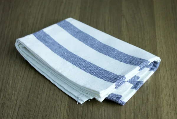 Folded napkin on wooden table — Stock Photo, Image