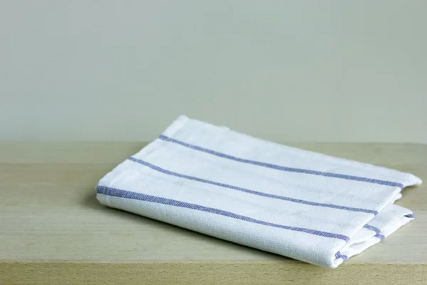 Folded napkin on wooden table — Stock Photo, Image