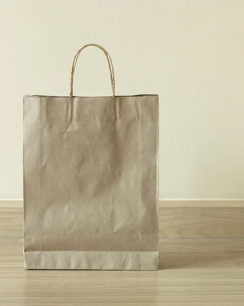 Brown paper bag on the floor — Stock Photo, Image