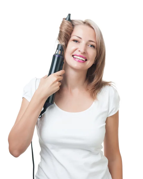 Beautiful girl doing hairstyle with hair brush — Stock Photo, Image