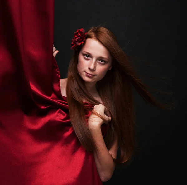 Krásná rusovlasá dívka vypadá zezadu červená divadlo cu — Stock fotografie