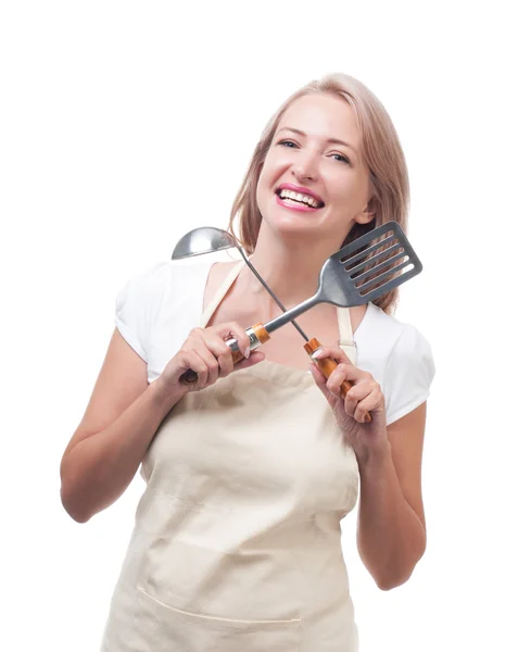 Beautiful housewife with ladle and spatula. Isolated on white ba — Stock Photo, Image