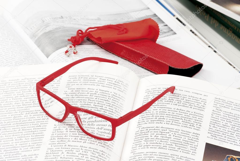 reading glasses endorsed on a book at home