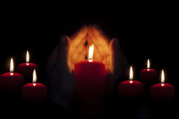 Two hands illuminated by  a candle in the darkness — Stock Photo, Image