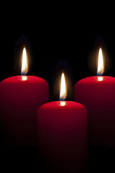 Red candles lighting in the darkness — Stock Photo, Image