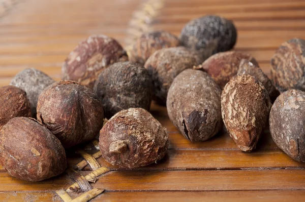 Shea nuts near butter on white background — Stock Photo, Image