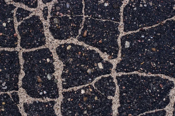 Old asphalt with stones. — Stock Photo, Image