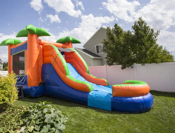 Inflatable bounce house water slide in the backyard — Stock Photo, Image