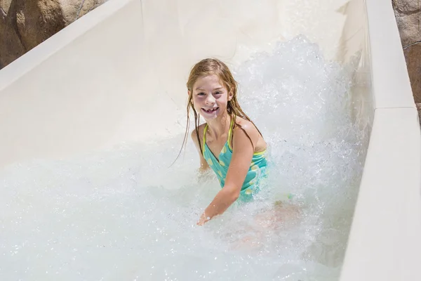 Happy little girl riding down — Stock Photo, Image