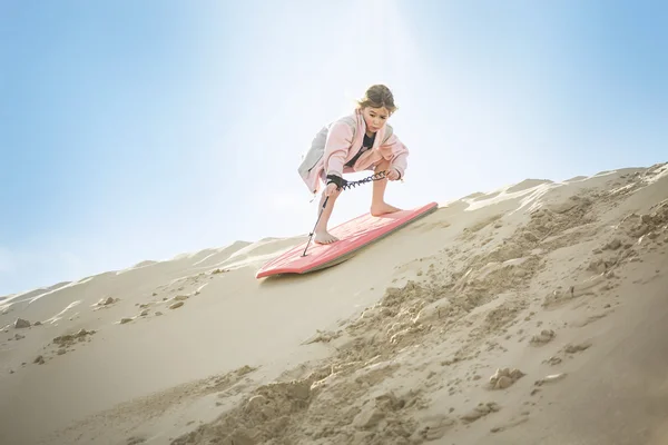 Little Girl boarding down the Sand Dune — Stock Photo, Image