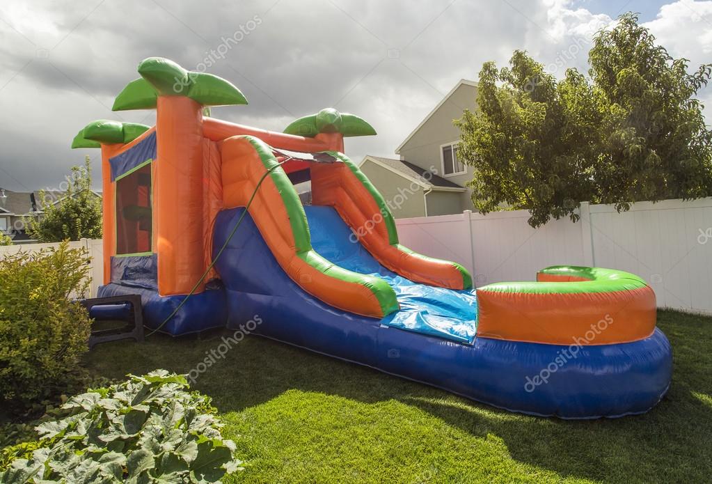 Inflatable bounce house water slide in the backyard — Stock Photo