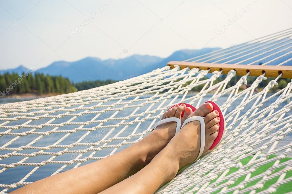 Woman relaxing in a hammock on a beautiful Mountain Lake.