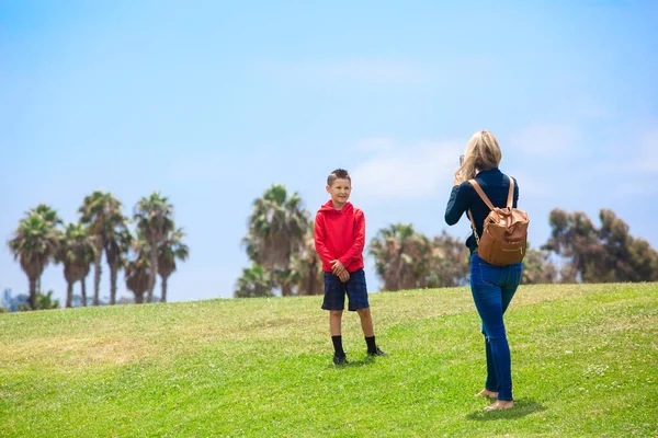 Mother Taking Cell Phone Photo Her Posing Smiling Son Outdoor — Stock Photo, Image