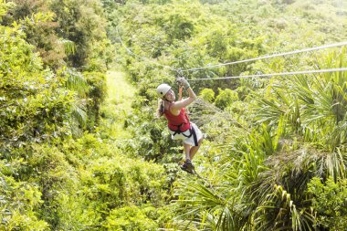 Woman going on a jungle zipline clipart