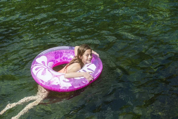 Girl playing  on inflatable tube — Stock Photo, Image