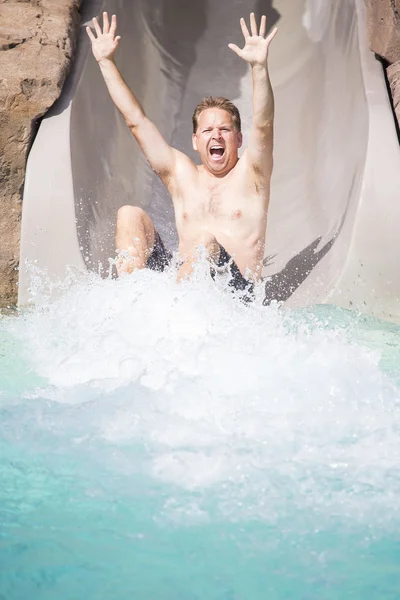 Man enjoying water slide — Stock Photo, Image