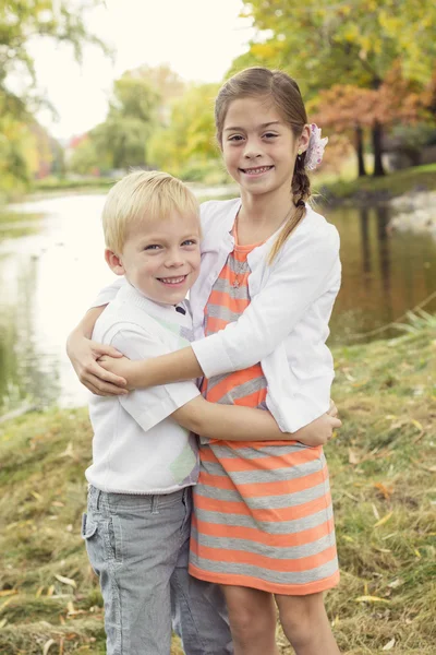 Boy and girl with a scenic fall — Stock Photo, Image