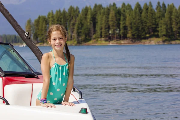 Девушка на моторной лодке по красивому озеру — стоковое фото