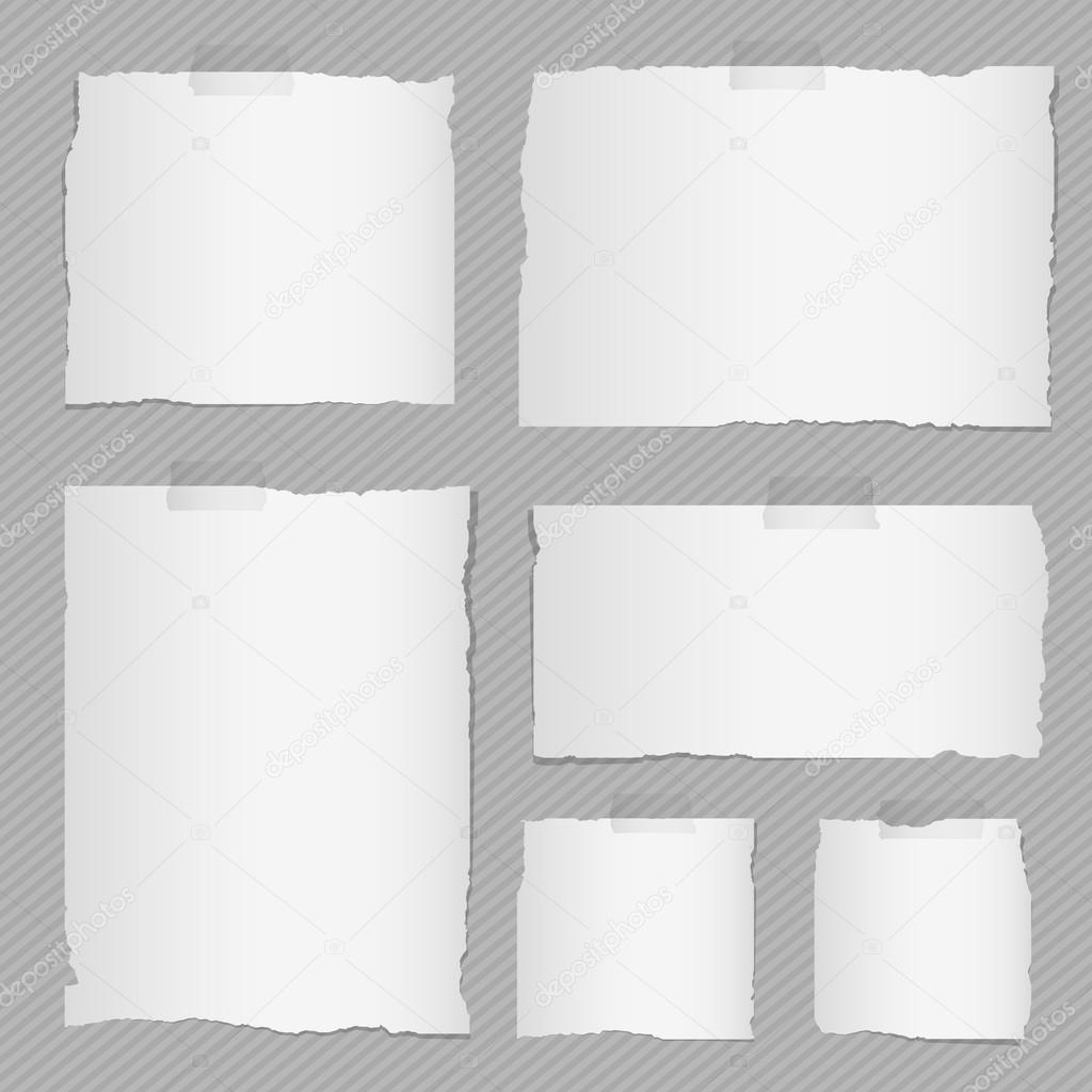 Pieces of torn white squared notebook paper with sticky tape on brown background