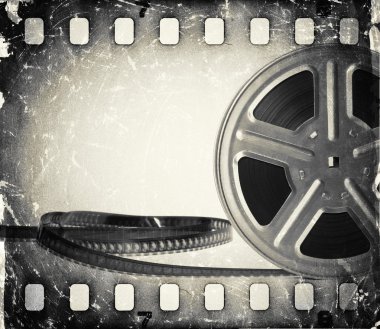Grunge old motion picture film reel with film strip. Vintage background clipart