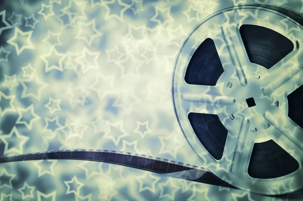 Motion picture film reel with strip and stars background — Stock Photo, Image