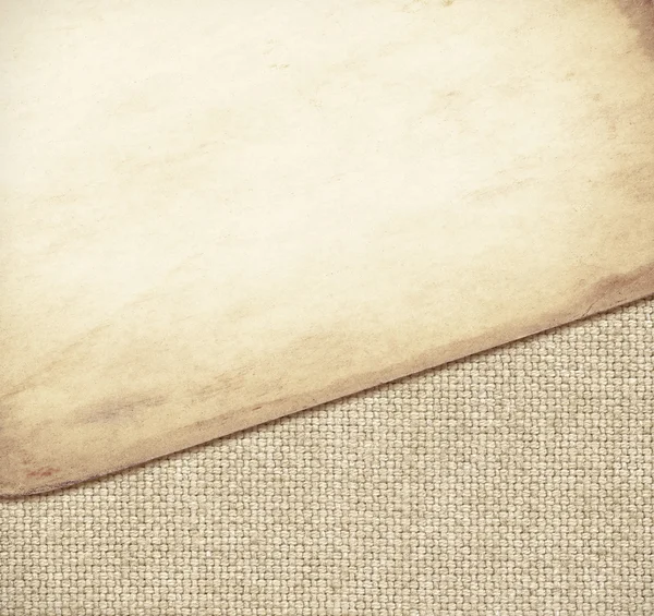Brown paper texture on burlap fabric — Stock Photo, Image