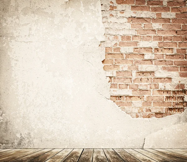 Tal brick wall with wooden floor — Stock Photo, Image