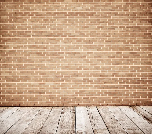 Tall brick wall with wooden floor — Stock Photo, Image