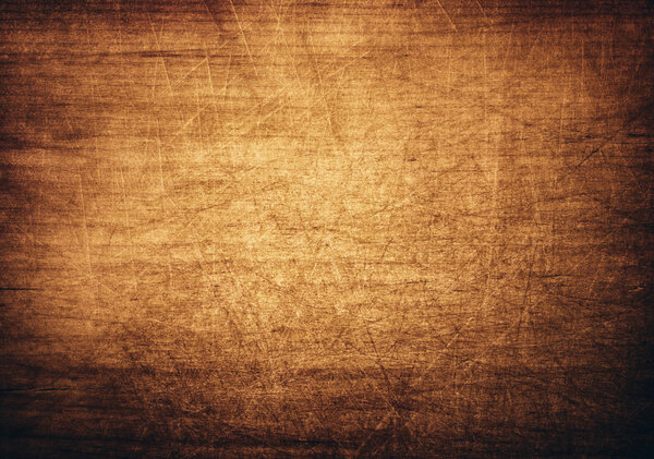 Brown, orange scratched wooden cutting board.