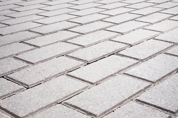 Grey brick stone street road. Light sidewalk, pavement texture — Stock Photo, Image