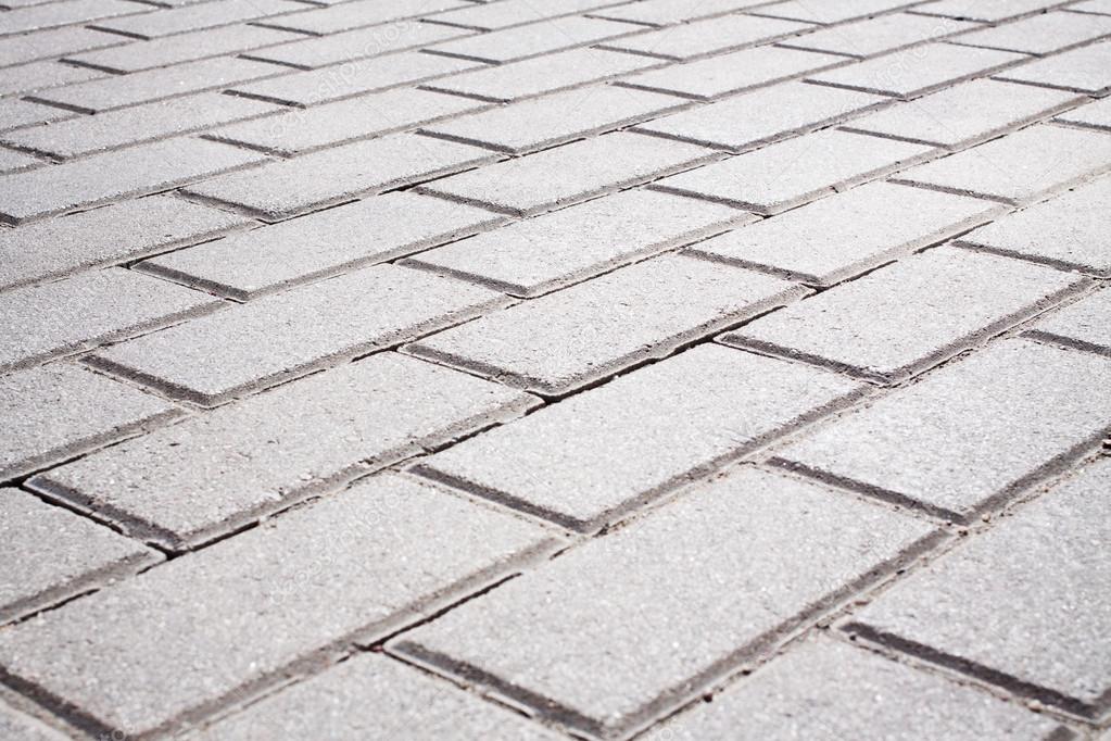 Grey brick stone street road. Light sidewalk, pavement texture