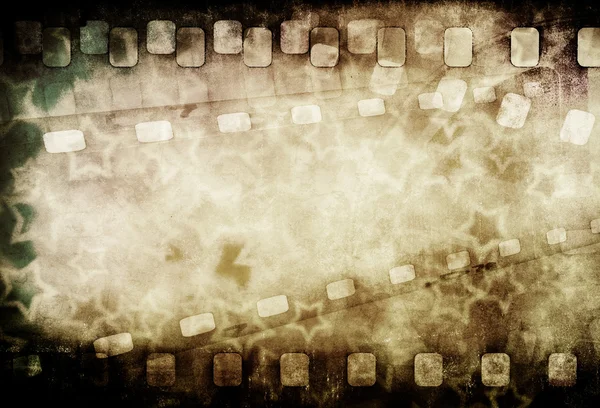 Grunge old motion picture reel with film strip and stars. Vintage background — Stock Photo, Image