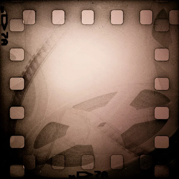 Grunge carrete de película vieja con tira de película. Fondo vintage — Foto de Stock