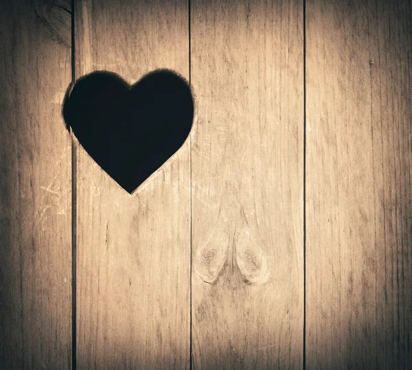 Heart shape cut on wooden wall, toilet, wc door or window — Stock Photo, Image