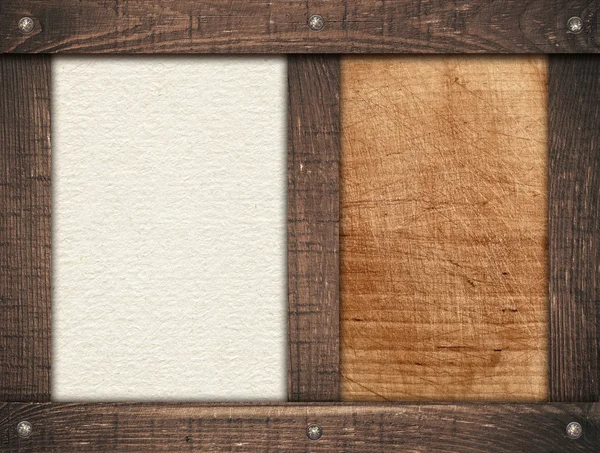 Brown wooden frames screwed on scratched wood board and light paper — Stock Photo, Image