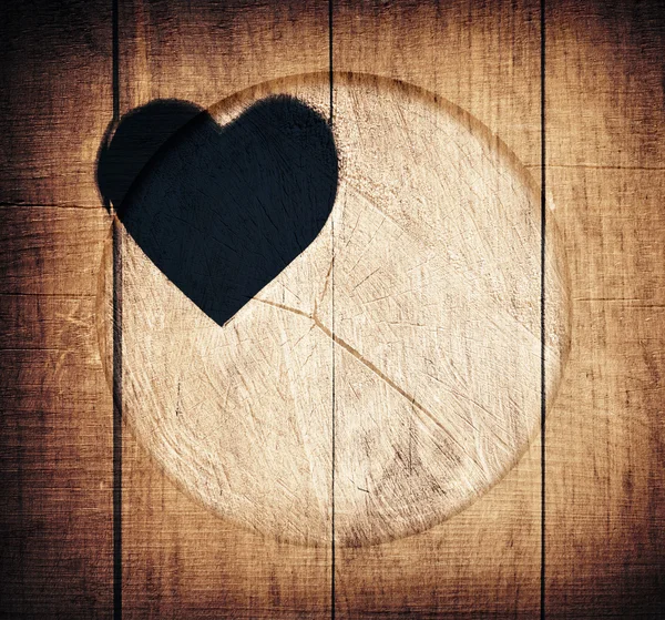 Double exposure of heart shape and wooden circle — Stock Photo, Image