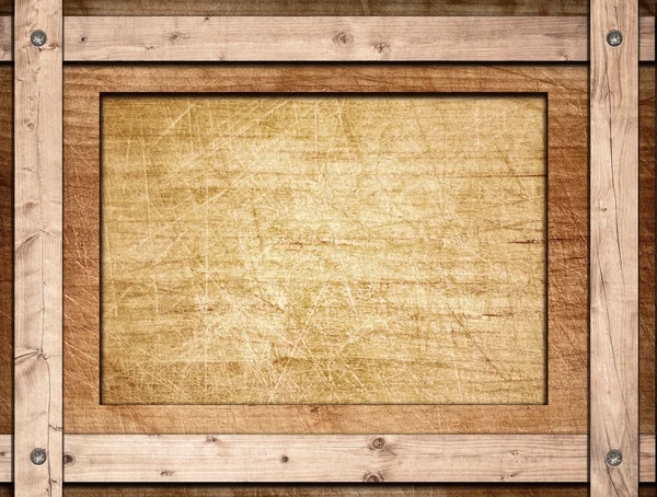 Brown frame screwed on wooden board — Stock Photo, Image