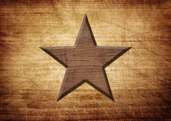 Wooden star decoration on brown scratched board — Stock Photo, Image