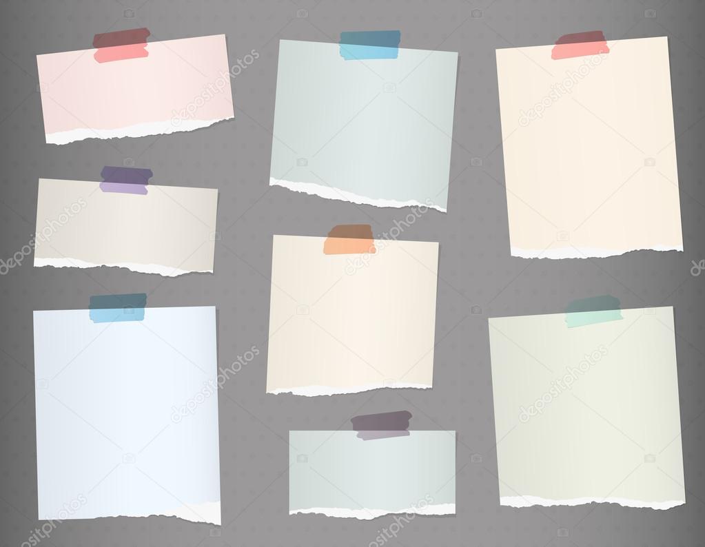 Pieces of torn colorful blank note paper on gray background