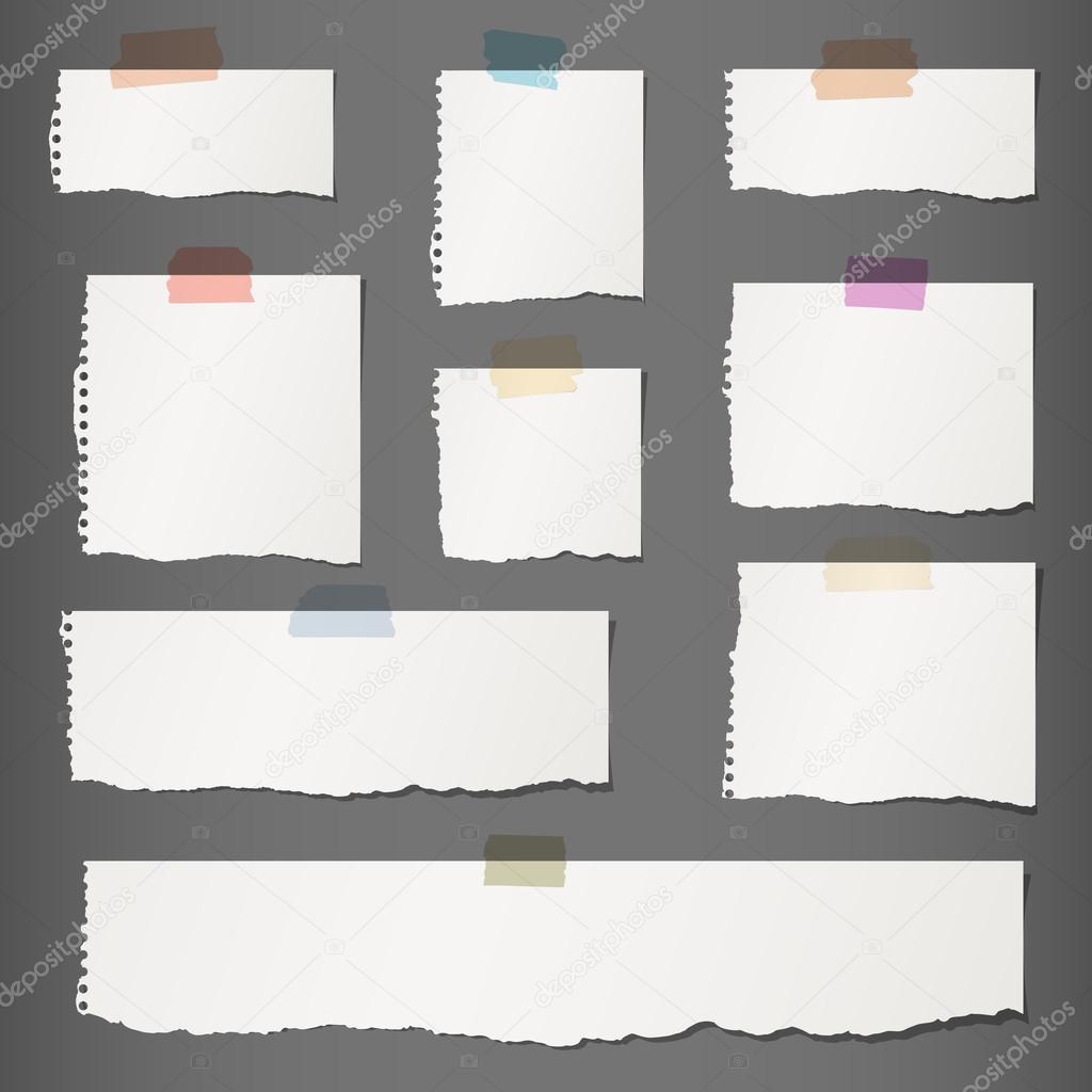 Pieces of torn white blank note paper with colorful sticky tape on dark gray background