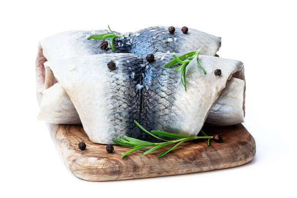 Marinated  herring rolls with herbs isolated on white 