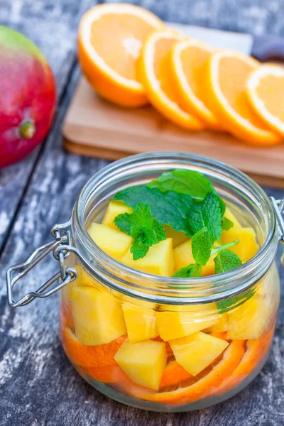 Homemade fruit drink with mango orange and mint - Stock-foto